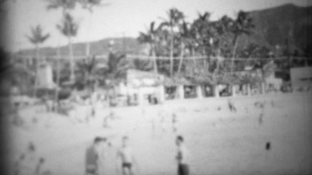1953: Waikiki beach underdeveloped diamondhead visitors playing.
