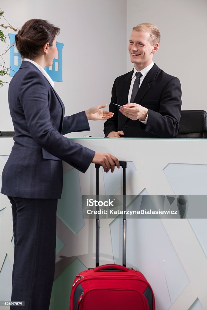 Businesswoman checking in Elegant businesswoman checking in at the hotel Adult Stock Photo