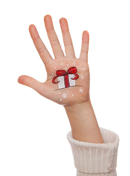 istock Kid's hands with painted Christmas symbols 526918537