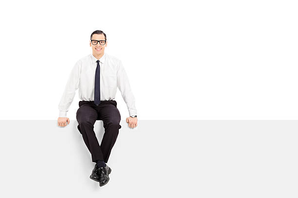 istock Young businessman sitting on a blank billboard 526920419