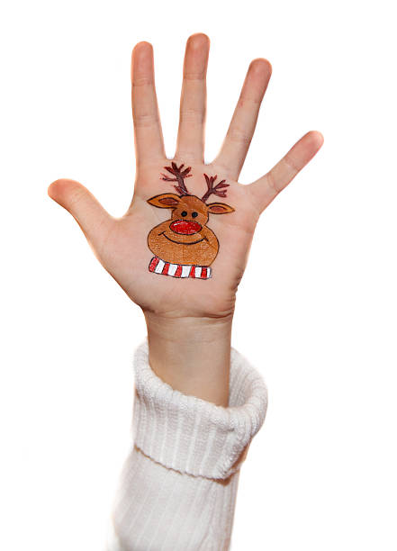 istock Kid's hands with painted Christmas symbol 526920841