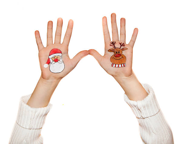 istock Kid's hands with painted Christmas symbols 526920847