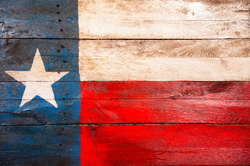 Rustic Texas, USA flag created from old wooden boards that have been painted red, white and blue.  A lone star to left. Weathered, handmade craft. Great background. 