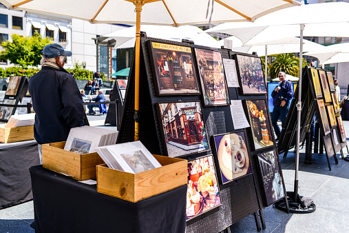 San Francisco, USA - May 23, 2013: Outdoor Art Gallery on Union Square, San Francisco, organized by  Artist's Guild of San Francisco, group of urban artists, wishing to exhibit their work in outdoor places in San Francisco,  founded in 1961. People visiting Gallery, looking at Artwork