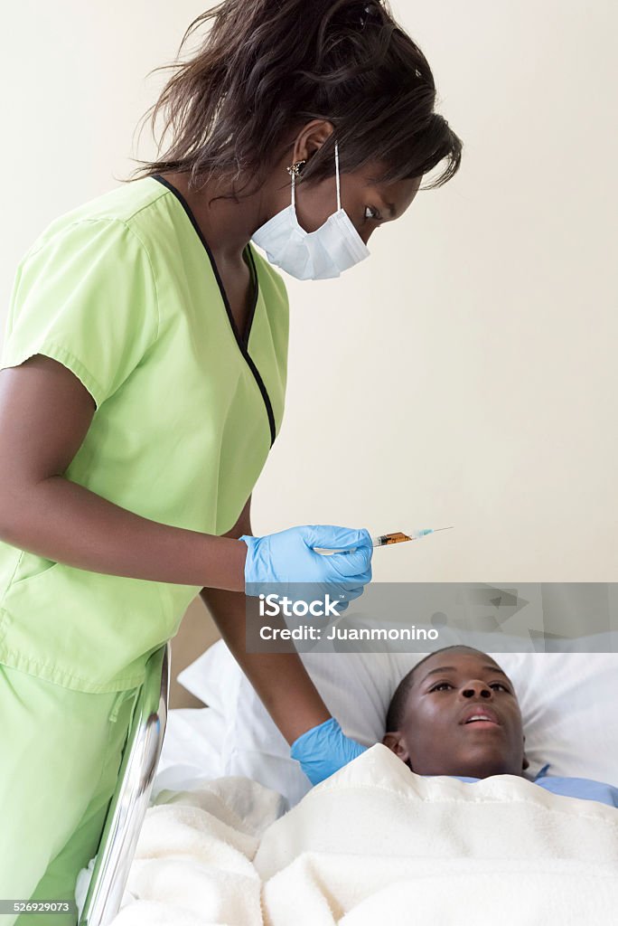 fear of needles scared teenage boy, the nurse is going to give him a shot 14-15 Years Stock Photo