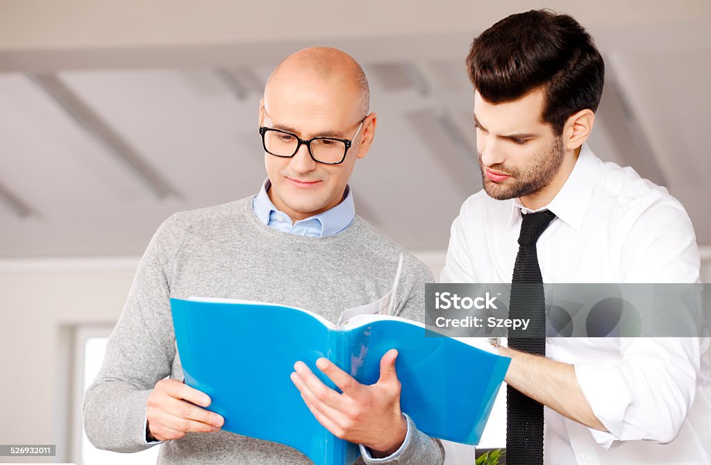 Teamwork at office Sales team reading presentation at office. Business group. Active Seniors Stock Photo