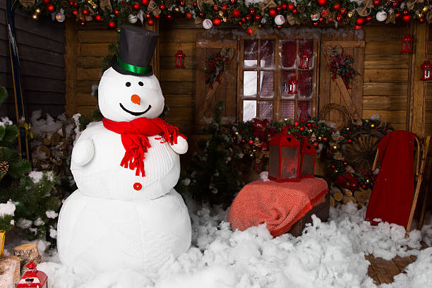 istock Large snowman on decorated wooden house 526932519