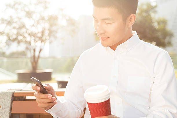 istock Businessman using smartphone during break outdoor 526934307