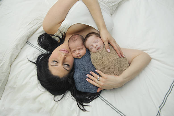 istock Mother Sleeping with Newborn Twin Brothers 526934715
