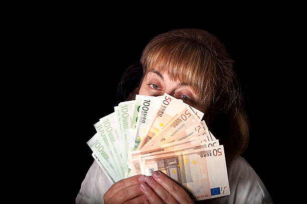 istock Woman Holding Cash 526943033