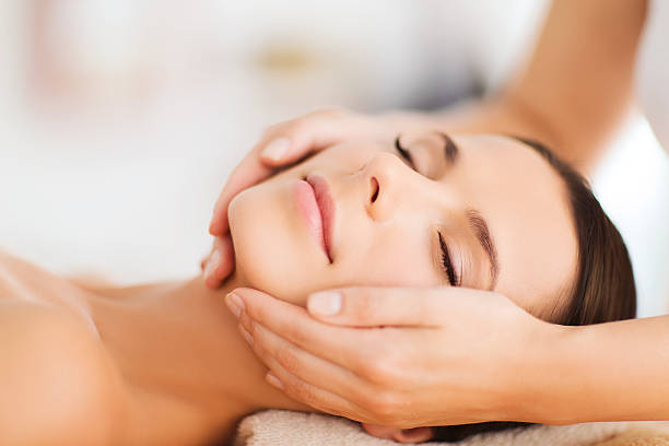 hermosa mujer con un tratamiento facial en el salón de belleza del spa - facial massage human face women beauty fotografías e imágenes de stock