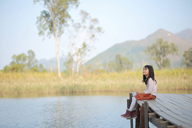 istock girl in front of a lake 526943695