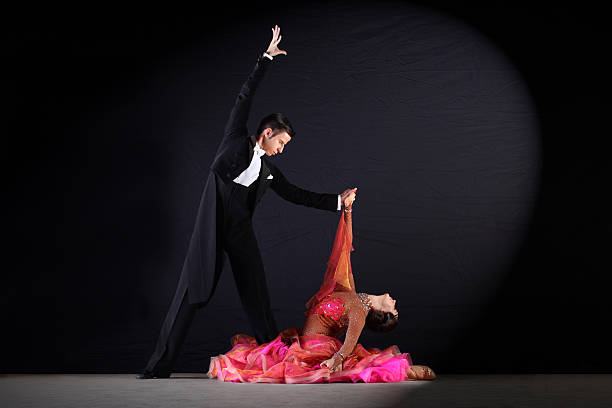 istock dancers in ballroom at black background 526943943