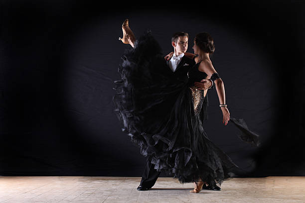 istock dancers in ballroom against on black background 526944017