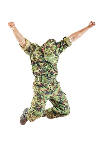 istock soldie in camouflage uniform and hat jumping 526944433