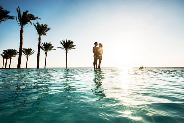 istock Loving couple at infinity pool. 526945119