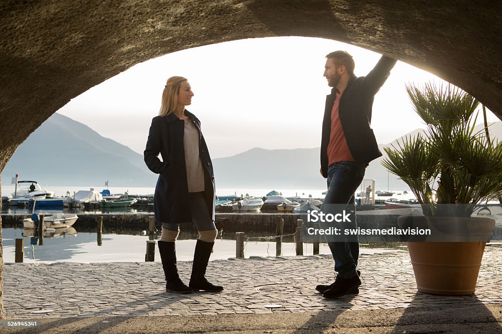 View from tunnel of couple in conversation,Autumn View from tunnel of couple in conversation, Autumn in Switzerland. 20-24 Years Stock Photo