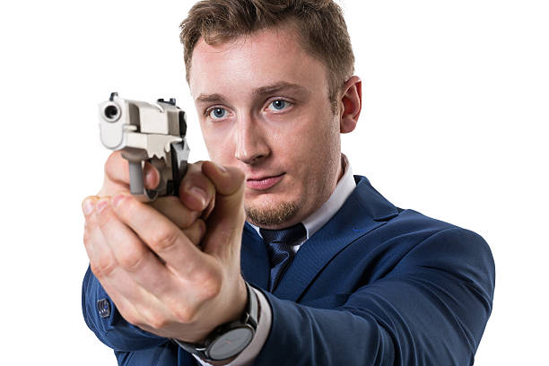 istock Businessman with gun 526946329