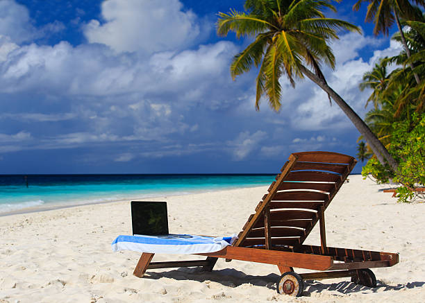 istock laptop on chair in tropical vacation 526946721