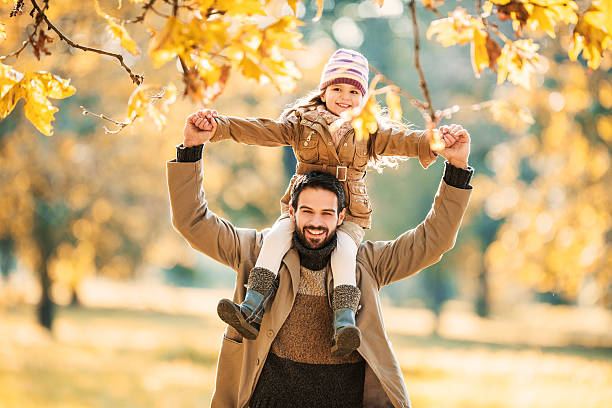 istock Father and daughter having fun in autumn. 526947671