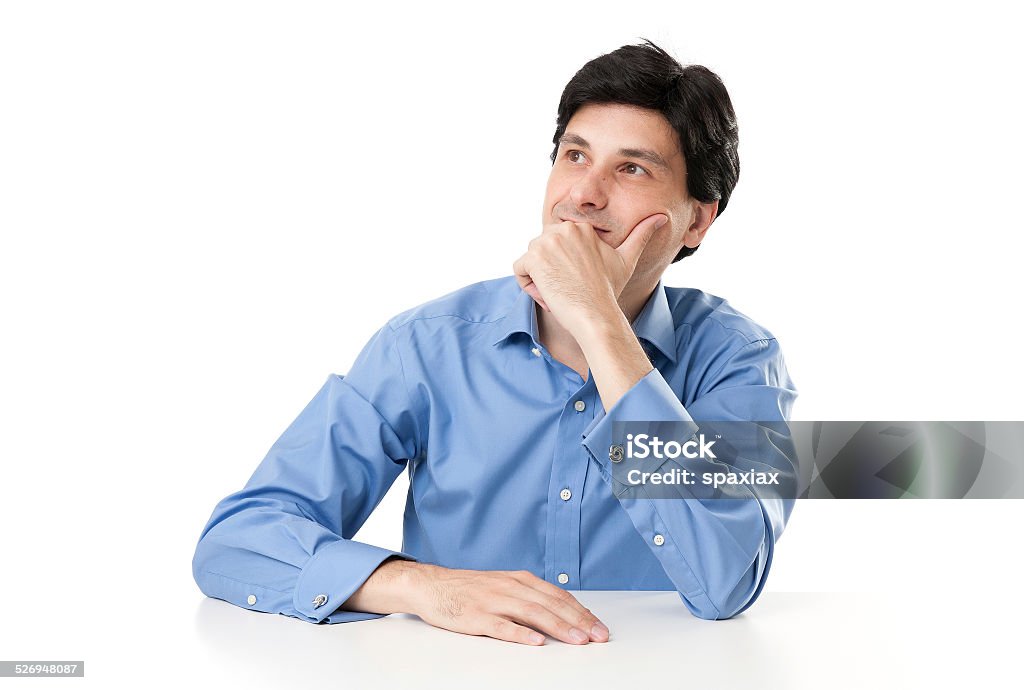 Businessman thinking businessman sitting at desk and looking away. Isolated Adult Stock Photo