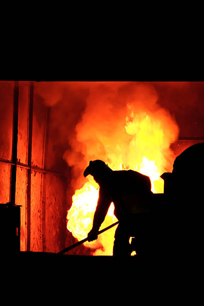 istock Man working in the splashing molten iron - Stock Image 526948675