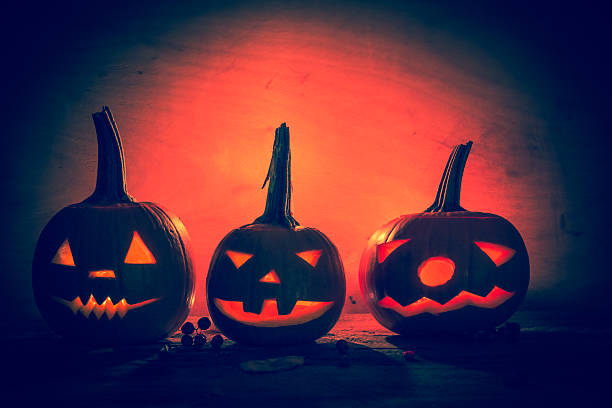 istock Halloween pumpkin lanterns dark light angry face fall 526948691