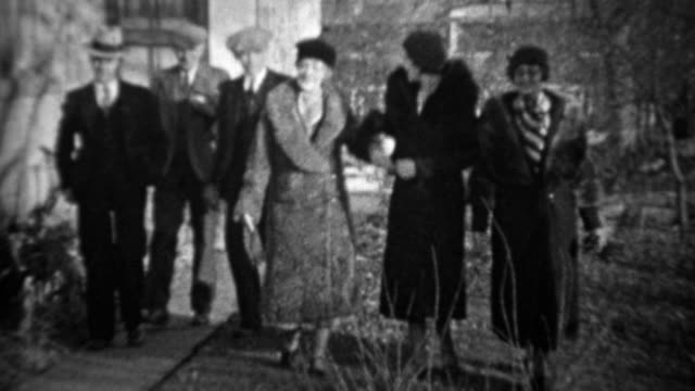 1933: Men greeting women tipping cap bowing to pretty wifes.