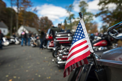 Flag hanging from a motorcycle in Dummerston, Vermont.  Lots of Harly's and other large touring bikes at this apple festival which is held each year during the fall.  