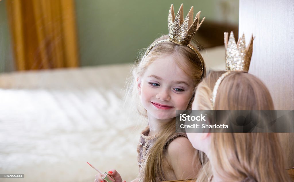 The little princess looks in the mirror Girls Stock Photo