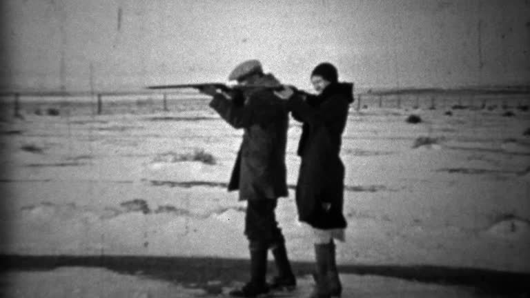 1933: Bonnie & Clyde depression era couple posing with guns.