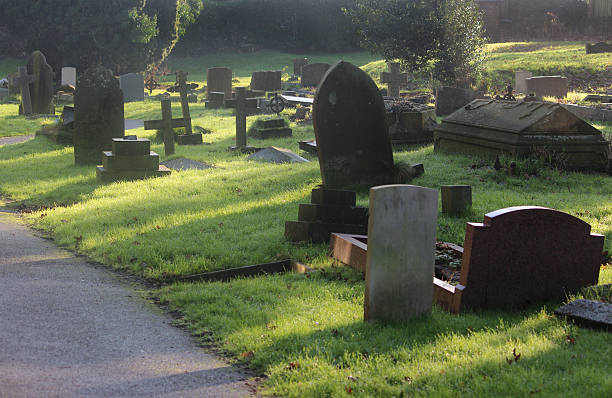 istock Neglected RIP gravestones / crosses, church graveyard cemetery image, leaning / falling-over 526956979