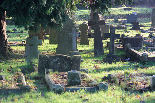 istock Neglected RIP gravestones / crosses, church graveyard cemetery image, leaning / falling-over 526956985