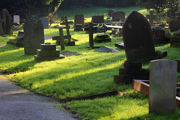 istock Neglected RIP gravestones / crosses, church graveyard cemetery image, leaning / falling-over 526956989