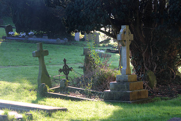 istock Neglected RIP gravestones / crosses, church graveyard cemetery image, leaning / falling-over 526956995