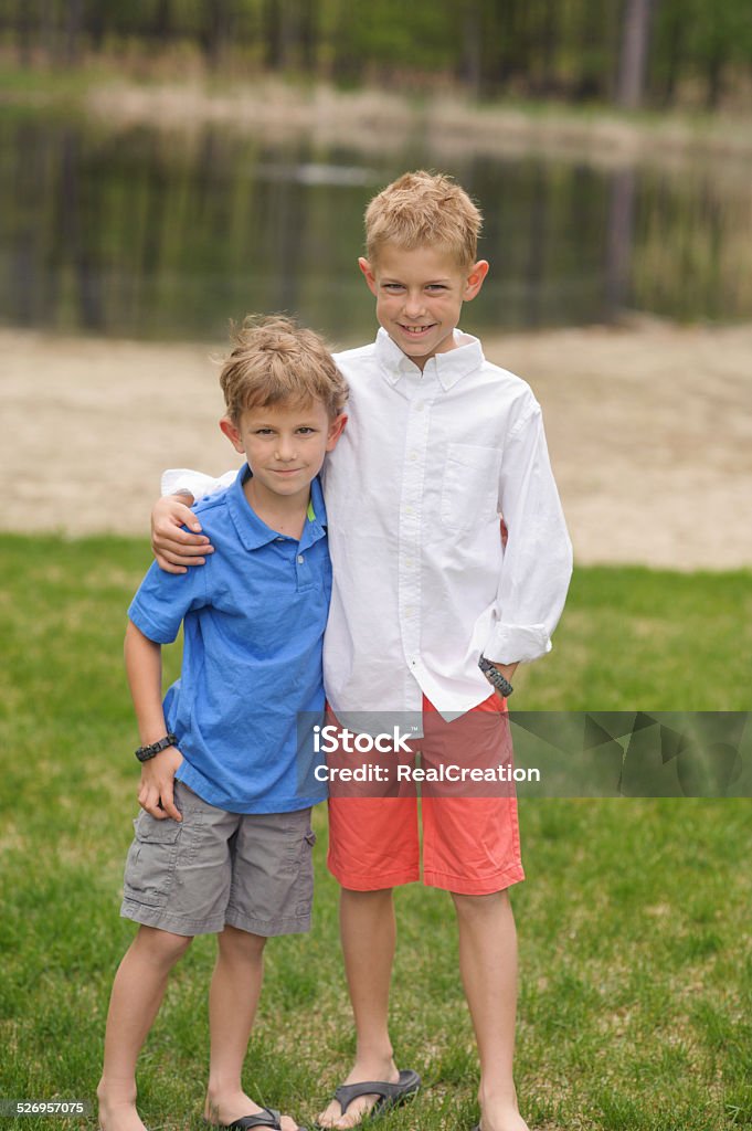 Two Brothers Outside Two brothers posing for a portrait. Boys Stock Photo