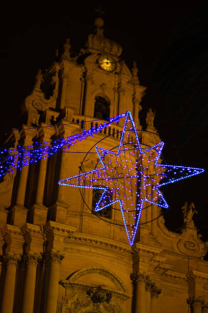 istock Illuminated Christmas Star Against Church & Black Sky 526957909
