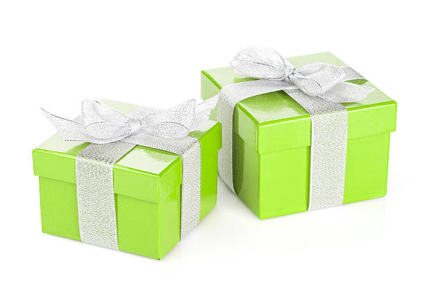 Two green gift boxes with silver ribbon and bow. Isolated on white background