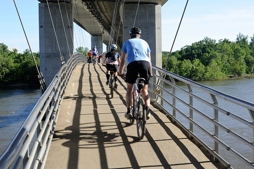 Richmond, USA - May 26, 2013. People biking on bridge over James River in Richmond, Virginia. Richmond is the state capital of Commonwealth of Virginia with a population of over 200,000.