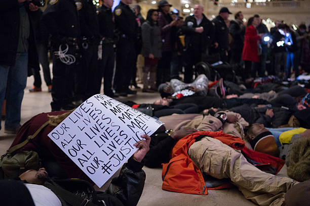 Eric Garner Protestors Lie on Floor of Grand Central Terminal New York City, USA - December 6, 2014: Demonstrators Lie on Floor of Grand Central Terminal to protest the deaths of Eric Garner and Michael Brown and the acquittals of the police officers who killed them. Chants of "I can't breathe" and "Hands Up, Don't Shoot!" where heard. i cant breathe stock pictures, royalty-free photos & images