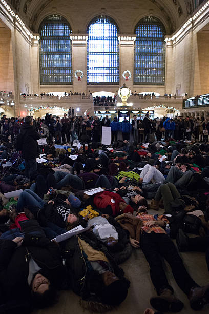 Eric Garner Protestors Lie on Floor of Grand Central Terminal New York City, USA - December 6, 2014: Demonstrators Lie on Floor of Grand Central Terminal to protest the deaths of Eric Garner and Michael Brown and the acquittals of the police officers who killed them. Chants of "I can't breathe" and "Hands Up, Don't Shoot!" where heard. i cant breathe photos stock pictures, royalty-free photos & images