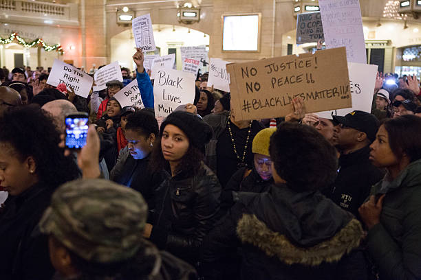 Eric Garner Protestors Lie on Floor of Grand Central Terminal New York City, USA - December 6, 2014: Demonstrators Lie on Floor of Grand Central Terminal to protest the deaths of Eric Garner and Michael Brown and the acquittals of the police officers who killed them. Chants of "I can't breathe" and "Hands Up, Don't Shoot!" where heard. i cant breathe stock pictures, royalty-free photos & images