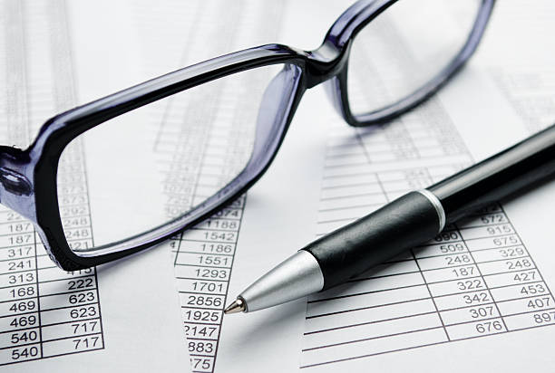 istock Eyeglasses and Pen on Top of Report Papers 526975103
