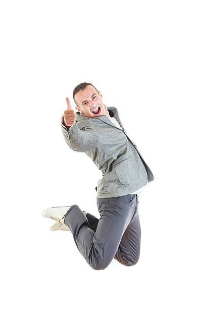 istock Man in suit laughing and jumping up with thumb up 526977271