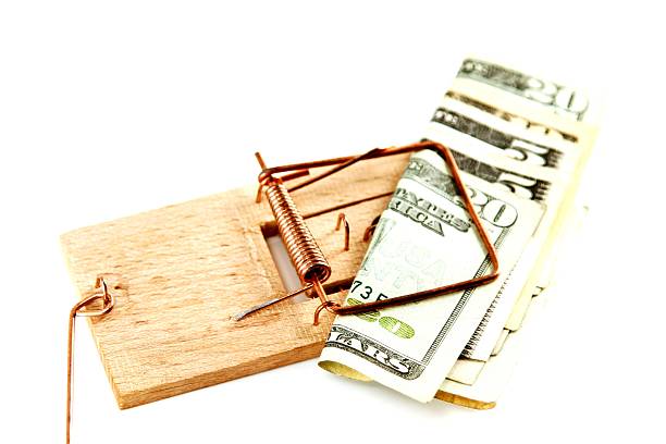 istock Dollar bills in a mousetrap 526977743