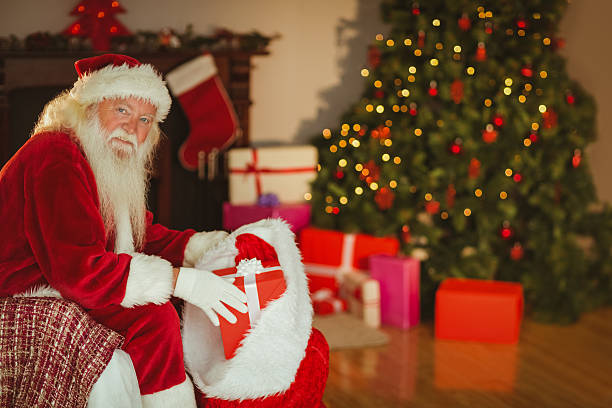 istock Smiling santa claus stocking gifts 526978401