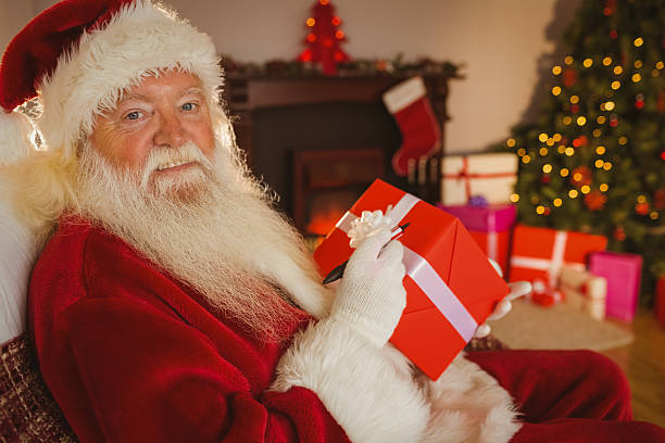 istock Smiling santa writing on a red gift 526978441