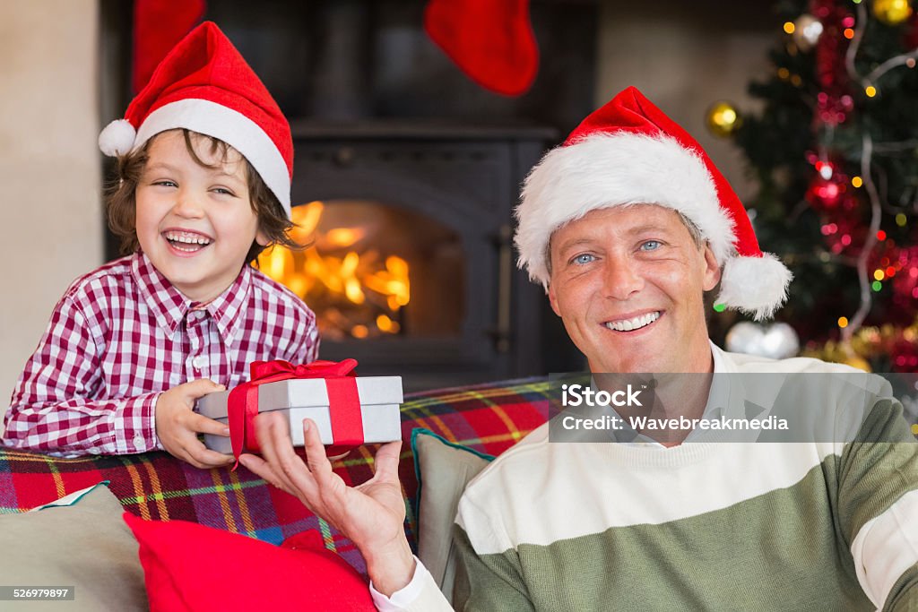 Portrait of smiling father and son at christmas Portrait of smiling father and son at christmas at home in the living room 40-44 Years Stock Photo