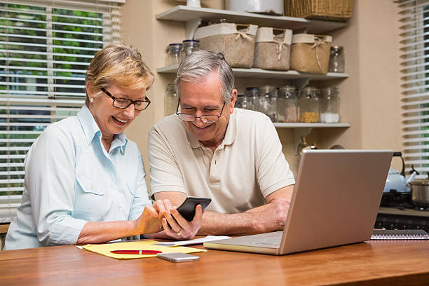 istock Senior couple working out their bills 526980165