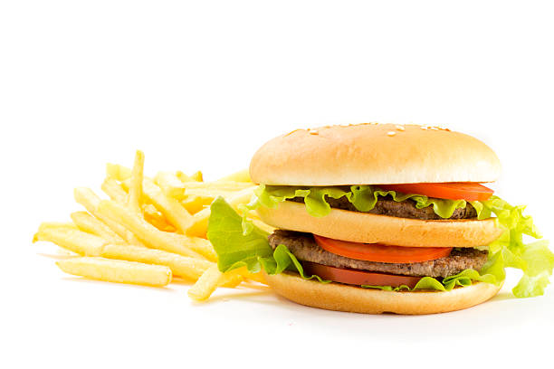 istock Big hamburger and fried potatoes isolated on white background 526980861
